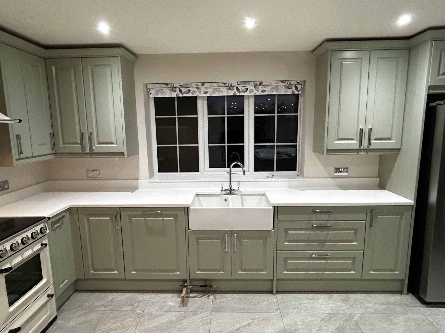 Sage green in-frame kitchen with Belfast sink and range cooker