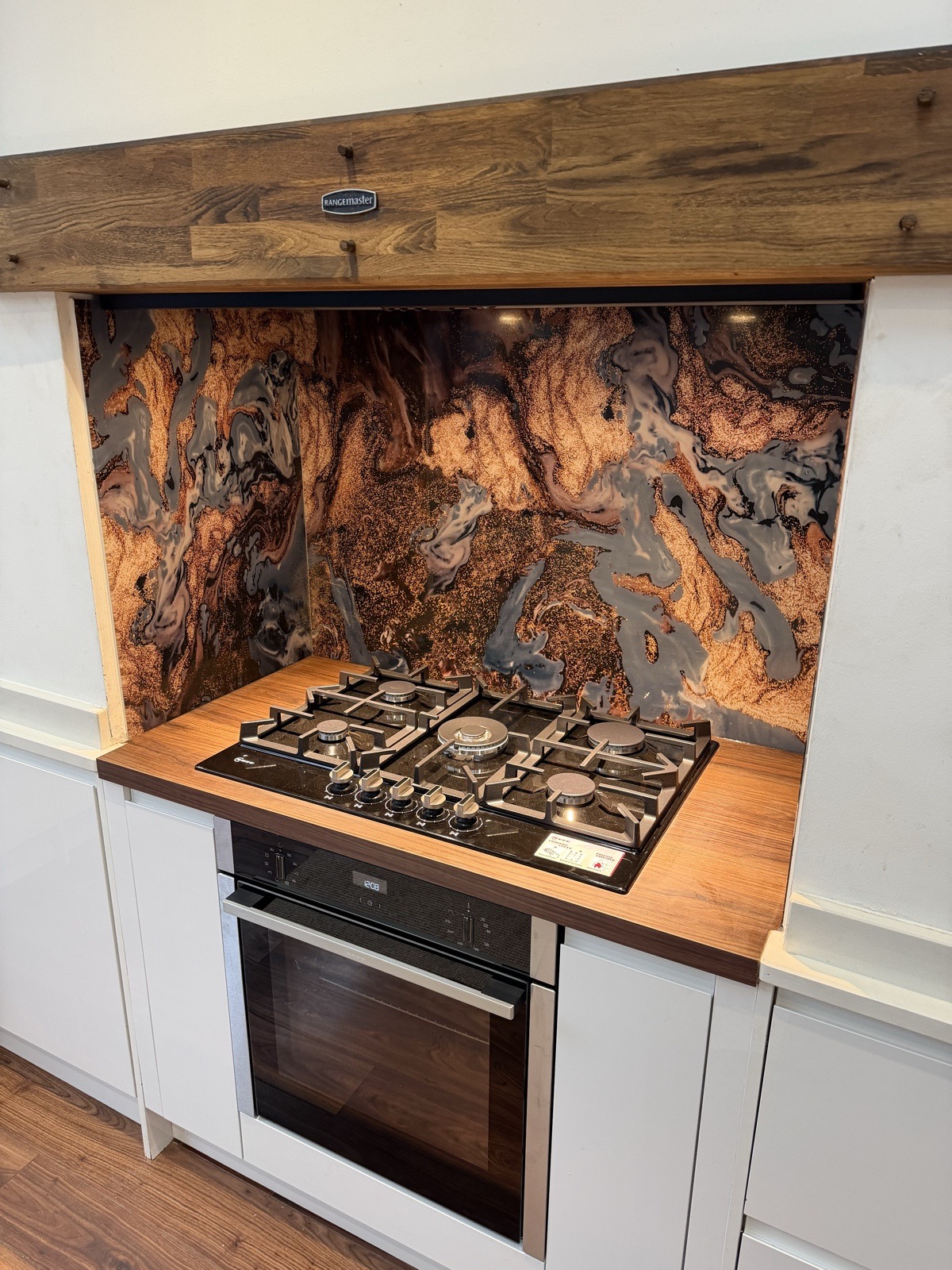 Finished cooking area in a genuine TLS Kitchens partial refit, with retained white cabinetry, timber surround and statement splashback